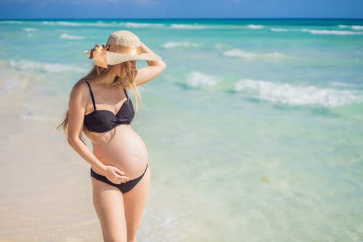 Radiant and expecting, a pregnant woman stands on a pristine snow-white tropical beach, celebrating the miracle of life against a backdrop of natural beauty.