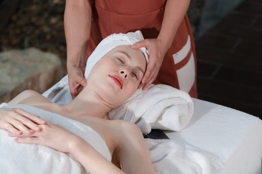 Attractive caucasian woman receive electrical facial treatment. Beautiful girl lies on spa bed while having medical treatment from professional doctor from medical spa center. Tranquility.