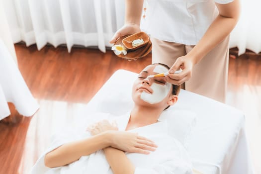 Serene ambiance of spa salon, woman customer indulges in rejuvenating with luxurious face cream massage with modern daylight. Facial skin treatment and beauty care concept. Quiescent