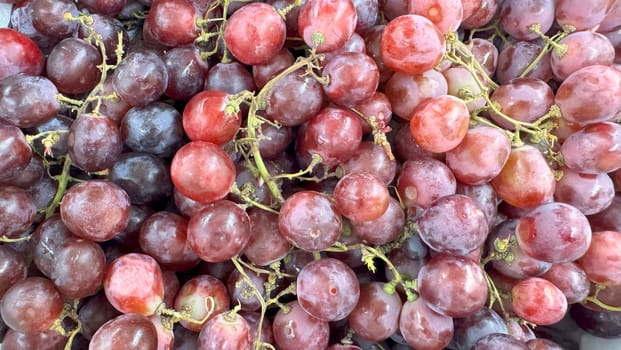 Close up of raw organic sweet red grapes background, wine grapes texture, Healthy fruits Red wine grapes background, top view fresh local produce, good for your multimedia content creation