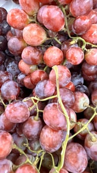 Close up of raw organic sweet red grapes background, wine grapes texture, Healthy fruits Red wine grapes background, top view fresh local produce, good for your multimedia content creation
