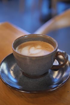 Coffee cup on wood table .