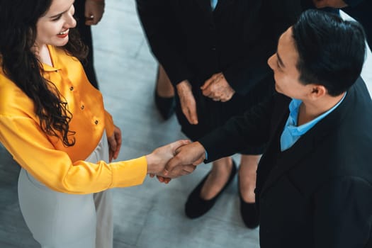 Businessmen shaking hand and making a contract in the sign of agreement, cooperation with businesswoman while smiling. Business people working together. Top view. Intellectual.