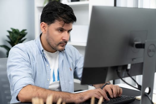 Creative professional freelancer concentrating and typing project deadline on keyboard. Creating design thinking of marketing online on pc laptop. In casual comfy at work from home theme. Sellable.