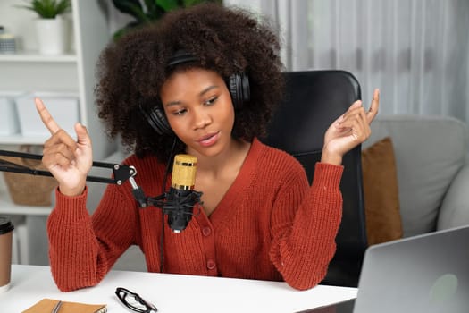 Host channel of beautiful African woman talking in online broadcast teaching marketing influencer, with listeners in broadcast or online. Concept of anywhere at work place. Tastemaker.