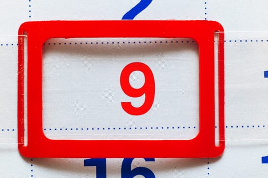 White calendar with a marked date ninth close up