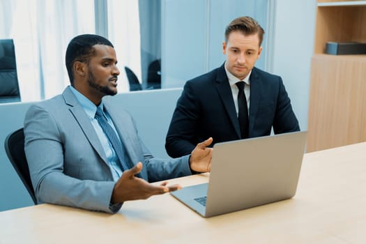 Cooperative handsome african businessman present start up project while manager listen and decide to invest. Two businesspeople making agreement, reporting data. Multicultural business. Ornamented.