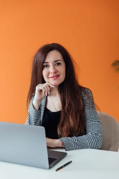 Beautiful woman working on laptop in office small business finance online