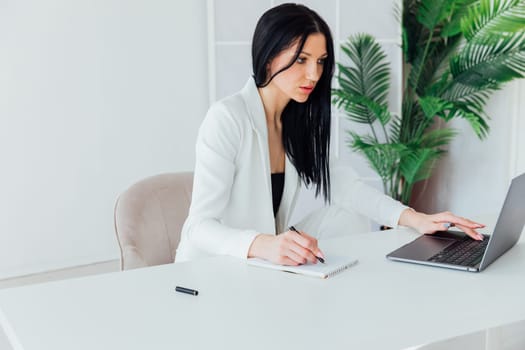 Woman in business suit working on laptop small business online office