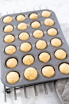 Cooling freshly baked American flag mini cupcakes on a kitchen counter.