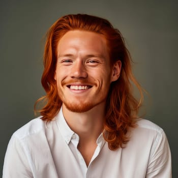 Handsome young male guy smile Asian with long red hair, on creamy beige background, banner, copy space, portrait. Advertising of cosmetic products, spa treatments, shampoos and hair care products, dentistry and medicine, perfumes and cosmetology men