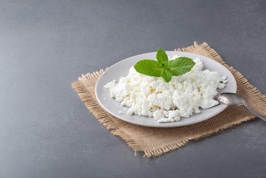 Cottage cheese in a bowl on a gray table.