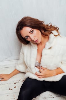 portrait of a beautiful woman with curls in a fur coat