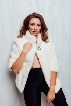 portrait of a beautiful woman with curls in a fur coat