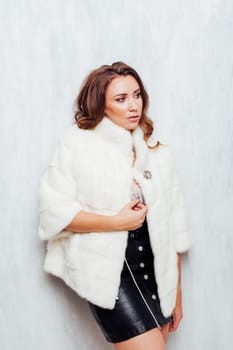 portrait of a beautiful woman with curls in a fur coat