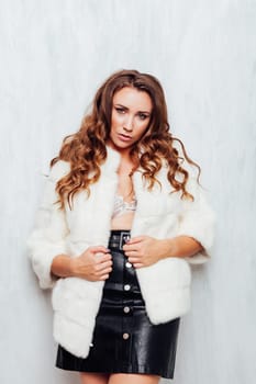 portrait of a beautiful woman with curls in a fur coat