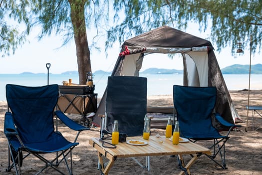 Unwind by the sea, Chairs, picnic table and tent create the perfect camping experience. Sunset, family, and the great outdoors this is where the journey to nature begins. The environment is calling.