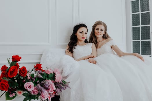 two girls sit next to the bride in White Hall wedding flowers