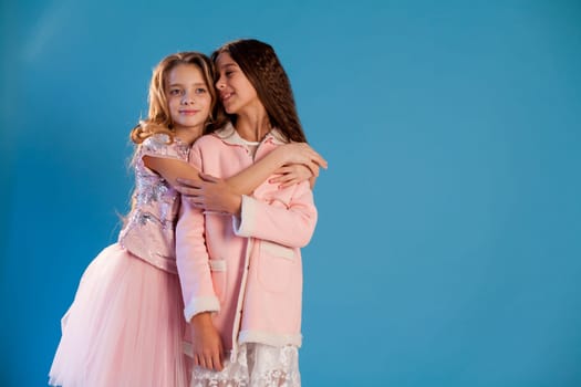 Portrait of two beautiful girl girlfriends in white pink clothes