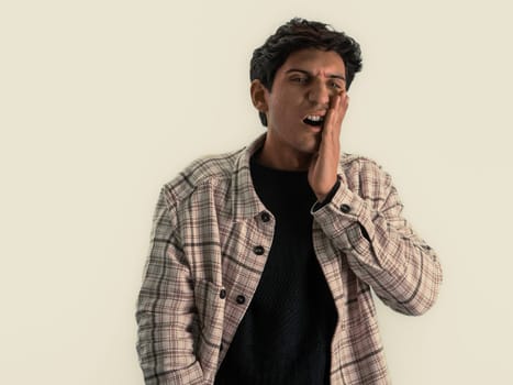 Good looking young man with hand on his face because of tooth ache in studio shot