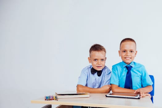 the two boys are looking at Internet Tablet school 1