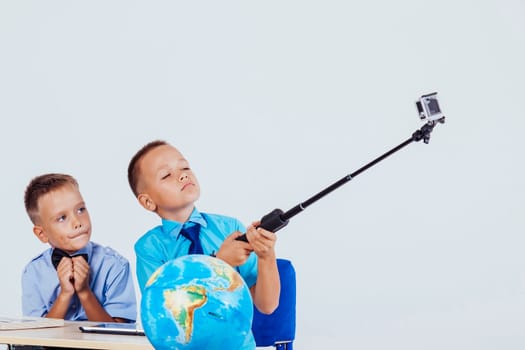 two boy photographed herself at her desk at school