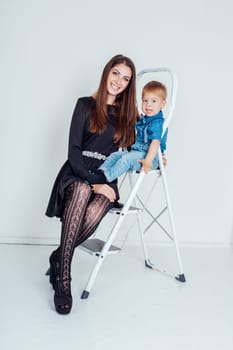 mother and young son on the stairs stepladder 1