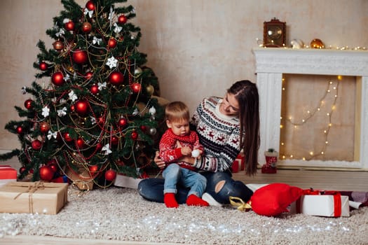 mom with son decorate the Christmas tree on new year's Day Gifts Christmas