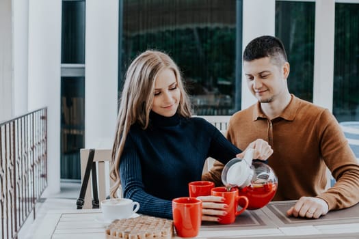 husband with wife on holiday drink hot coffee and tea 1