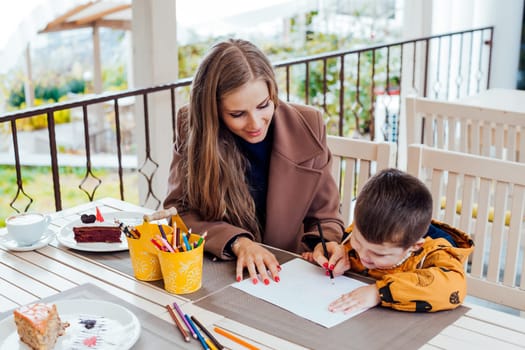 mother and son draw drawing hands colored pencils