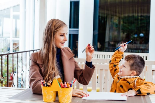 mom and young boy draw colored pencils 1