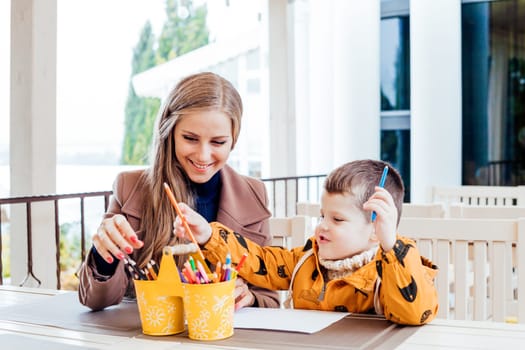 mom and young boy draw colored pencils 1