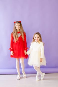 Two beautiful girls in red white dresses