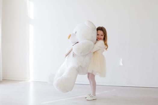Girl with soft bear toy gift