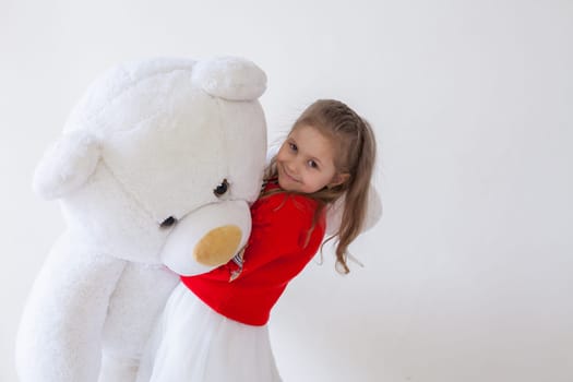 Girl with soft bear toy gift