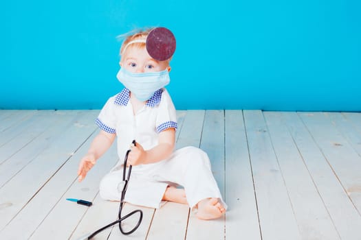 a little boy dressed as a doctor in the hospital