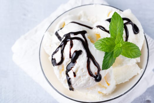 Bowl of vanilla ice cream isolated on white background.
