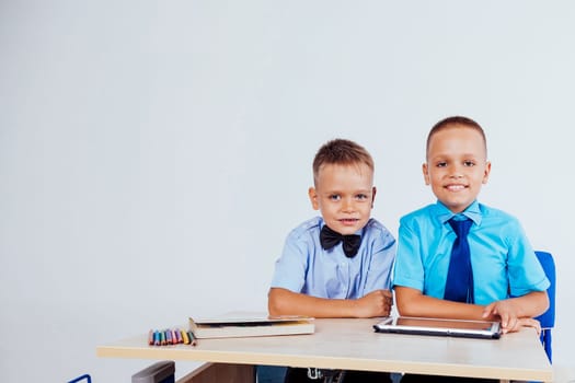 the two boys are looking at Internet Tablet school 1