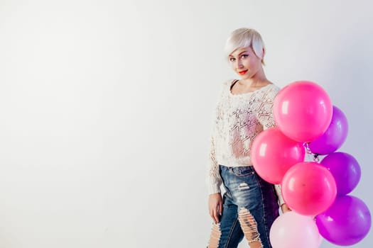 blonde girl with balloons and gift on a holiday 1