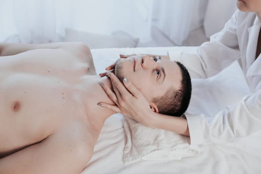 male masseuse makes a therapeutic massage in the Spa