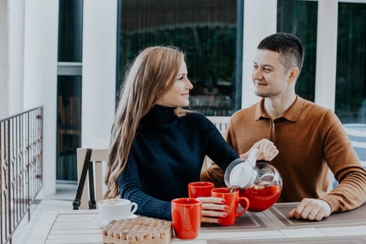 husband with wife on holiday drink hot coffee and tea 1