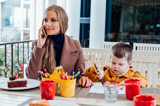 Restaurant mom with son talking on the phone 1