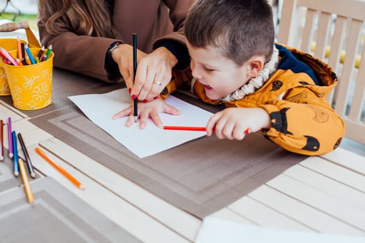 mother and son draw drawing hands colored pencils 1