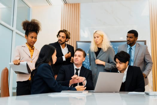 Multicultural businesspeople brainstorming business idea together. Diverse professional business team working together, sharing, planing idea, strategy. Meeting room, laptop, presentation. Ornamented.