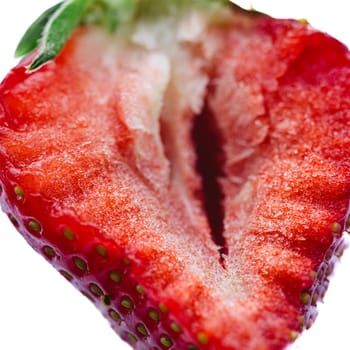 Ripe half of a strawberry on a white background. Shallow dof