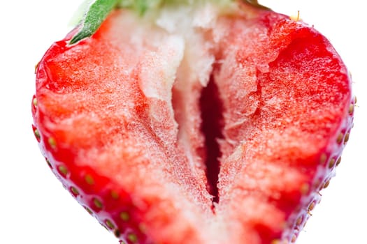 Ripe half of a strawberry on a white background. Shallow dof