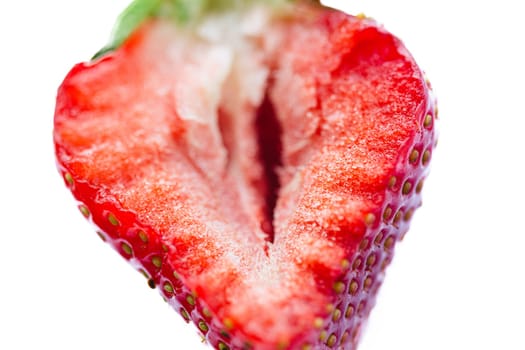 Ripe half of a strawberry on a white background. Shallow dof