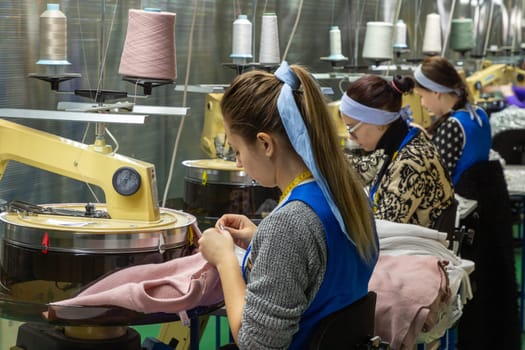 Grodno, Belarus - February 12, 2020: Women are engaged in tailoring of sweaters in LLC Conte Spa.