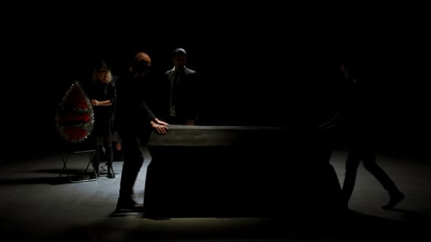 Theater stage. Stock footage. A drama unfolding with actors and a coffin where a man screams with an angry expression on his face. High quality 4k footage