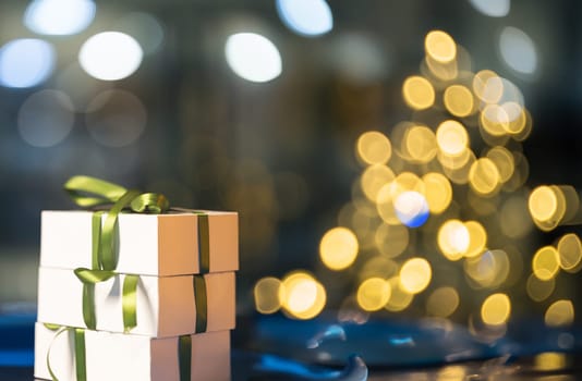 A gift box with a green bow sitting on a table